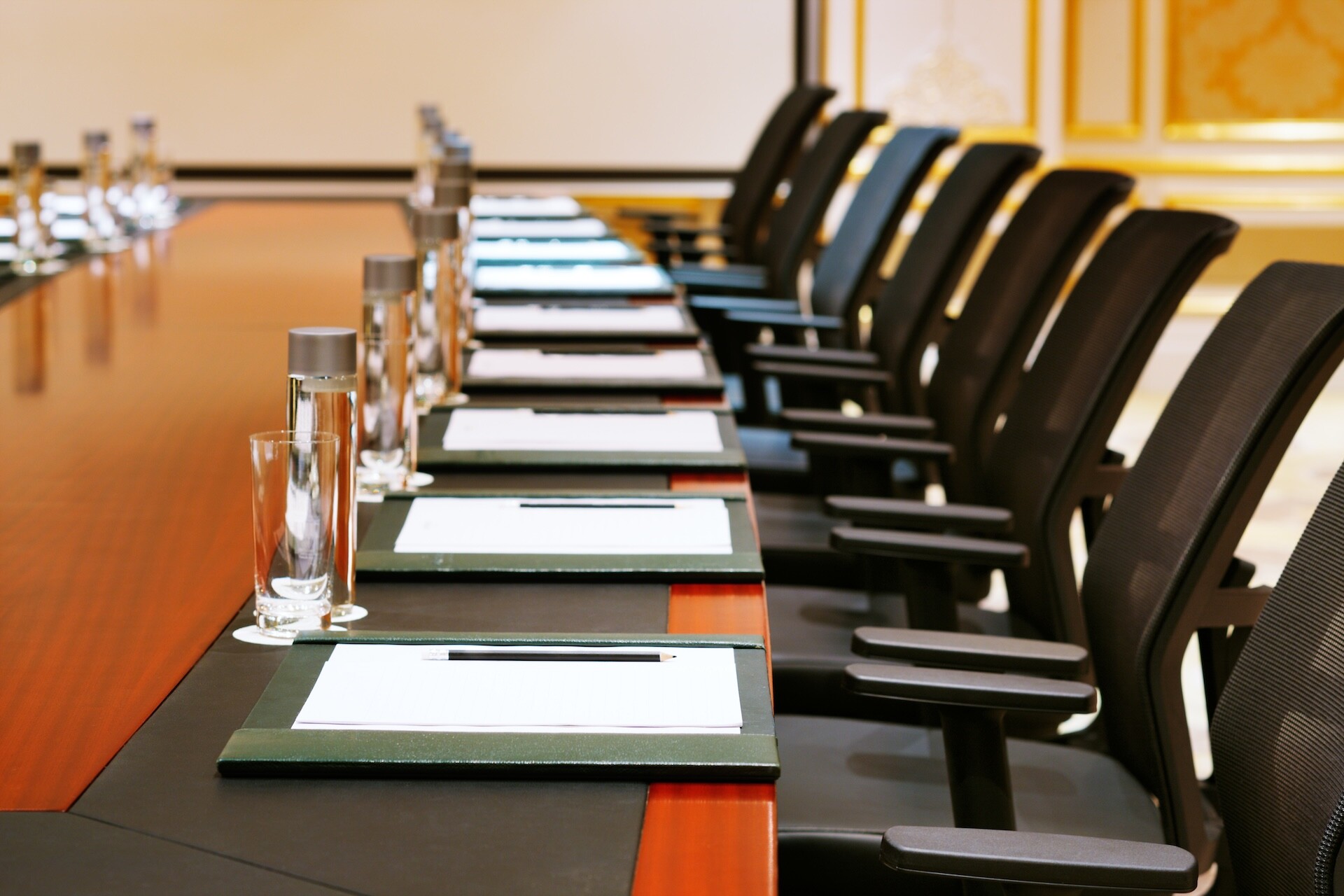 Business meeting table close up pens paper notebooks workshop