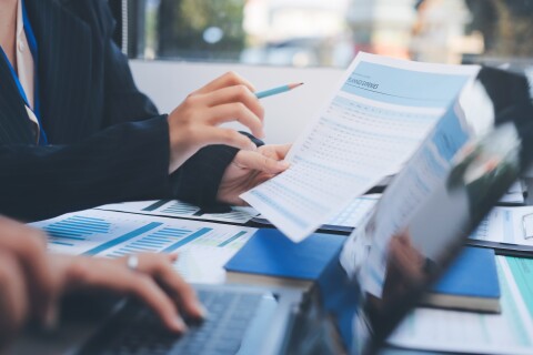 Financial analyst reviewing credit application reports modern office